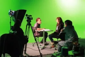 Teens in front of a green screen learning filmmaking